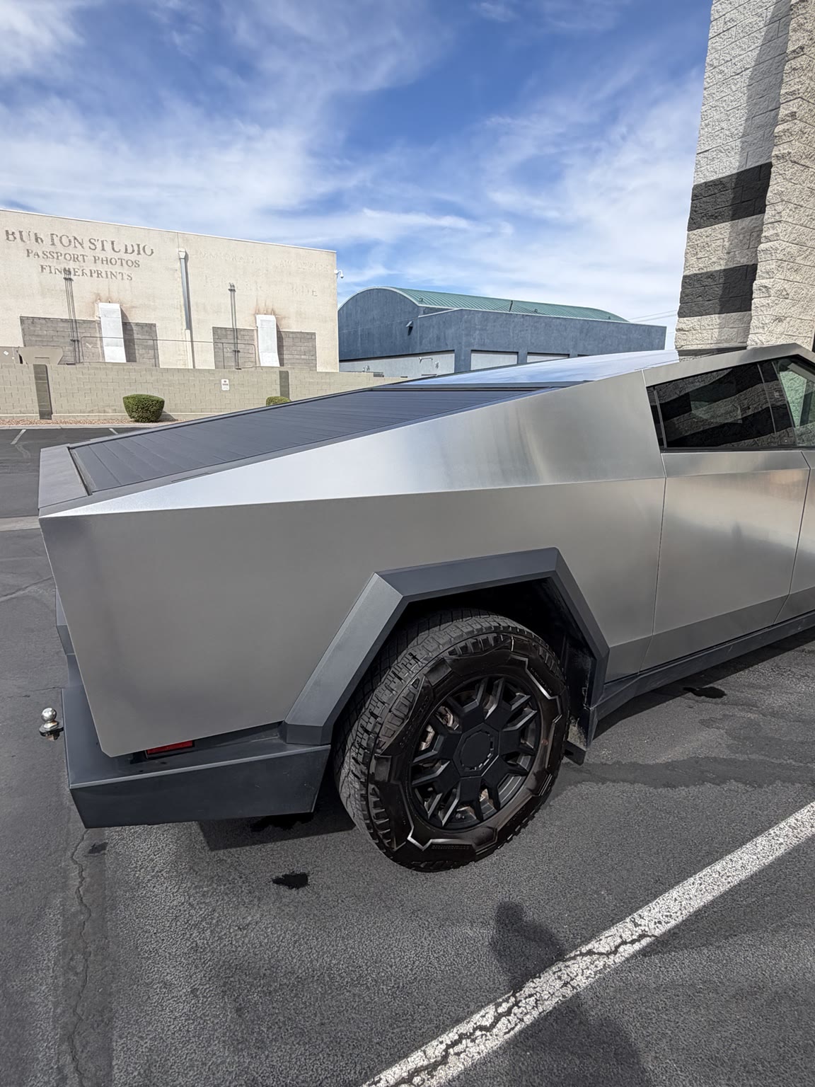 Side view of a restored stainless steel Cybertruck